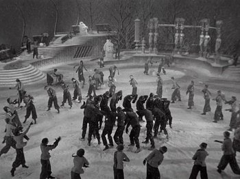 Movie still from “Gold Diggers of 1933” (1933), directed by Mervyn LeRoy – A group of people standing in the middle of an ice rink; Extreme Wide shot, High angle