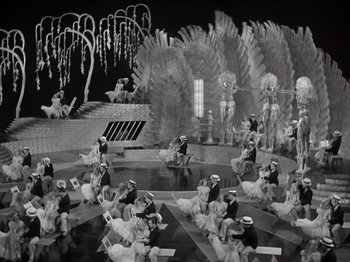 Movie still from “Gold Diggers of 1933” (1933), directed by Mervyn LeRoy – A black - and - white photo of a scene in a theater; Extreme Wide shot, High angle