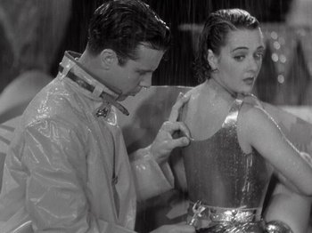 Movie still from “Gold Diggers of 1933” (1933), directed by Mervyn LeRoy – A man and a woman in a rain shower; Medium shot, Low angle