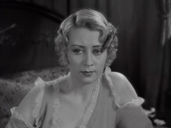 Movie still from “Gold Diggers of 1933” (1933), directed by Mervyn LeRoy – A black and white photo of a woman in a dress; Close Up shot, High angle
