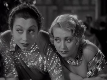 Movie still from “Gold Diggers of 1933” (1933), directed by Mervyn LeRoy – A couple of women sitting next to each other; Close Up shot, High angle