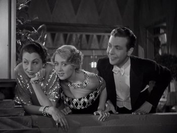 Movie still from “Gold Diggers of 1933” (1933), directed by Mervyn LeRoy – A group of people sitting next to each other on a couch; Medium shot, Low angle