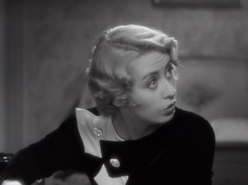 Movie still from “Gold Diggers of 1933” (1933), directed by Mervyn LeRoy – An old photo of an older woman with blonde hair looking to her left; Close Up shot, High angle
