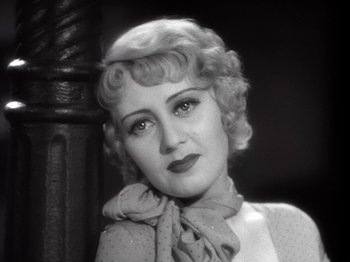 Movie still from “Gold Diggers of 1933” (1933), directed by Mervyn LeRoy – An old photo of a woman with a scarf around her neck; Close Up shot, High angle
