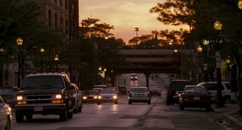 Movie still from “Gone Baby Gone” (2007), directed by Ben Affleck – Cars are driving down a street at dusk; Extreme Wide shot, High angle