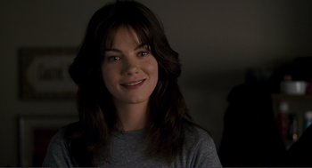 Movie still from “Gone Baby Gone” (2007), directed by Ben Affleck – A woman with long brown hair smiles for the camera; Close Up shot, Over the shoulder angle