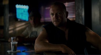 Movie still from “Gone Baby Gone” (2007), directed by Ben Affleck – A man sitting at a table in front of another man; Close Up shot, Over the shoulder angle