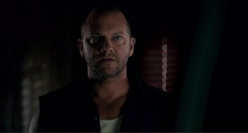 Movie still from “Gone Baby Gone” (2007), directed by Ben Affleck – A person wearing a black shirt; Close Up shot, Over the shoulder angle