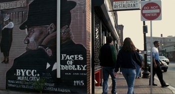 Movie still from “Gone Baby Gone” (2007), directed by Ben Affleck – Two people walking down the sidewalk in front of a restaurant; Close Up shot, Low angle