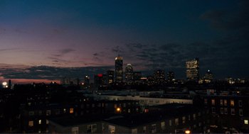 Movie still from “Gone Baby Gone” (2007), directed by Ben Affleck – A view of a city skyline at night time; Extreme Wide shot, High angle