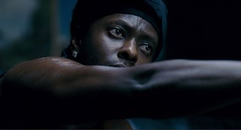 Movie still from “Gone Baby Gone” (2007), directed by Ben Affleck – A person wearing a black hat; Close Up shot, Low angle