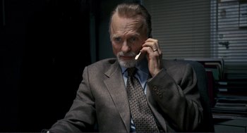 Movie still from “Gone Baby Gone” (2007), directed by Ben Affleck – An older man wearing a suit and tie while talking on a cell phone; Close Up shot, Low angle