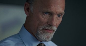 Movie still from “Gone Baby Gone” (2007), directed by Ben Affleck – An older man wearing a tie and a dress shirt; Close Up shot, Low angle