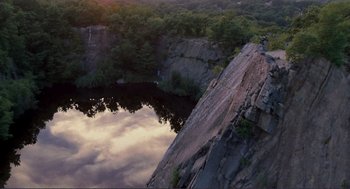 Movie still from “Gone Baby Gone” (2007), directed by Ben Affleck – A view of a body of water from a cliff; Extreme Wide shot, Overhead angle