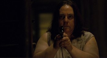 Movie still from “Gone Baby Gone” (2007), directed by Ben Affleck – A woman holding a cell phone in her hand; Close Up shot, Low angle