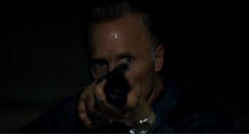 Movie still from “Gone Baby Gone” (2007), directed by Ben Affleck – A man taking a picture with a camera; Close Up shot, Low angle