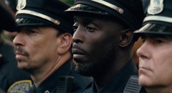 Movie still from “Gone Baby Gone” (2007), directed by Ben Affleck – A person wearing a hat; Close Up shot, Over the shoulder angle