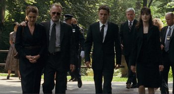 Movie still from “Gone Baby Gone” (2007), directed by Ben Affleck – A group of men in suits walking down a sidewalk; Wide shot, Low angle