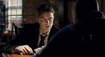 Movie still from “Gone Baby Gone” (2007), directed by Ben Affleck – A man sitting at a table in front of another man; Close Up shot, Over the shoulder angle