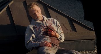 Movie still from “Gone Baby Gone” (2007), directed by Ben Affleck – A man with blood all over his body; Medium shot, High angle