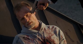 Movie still from “Gone Baby Gone” (2007), directed by Ben Affleck – A man with blood all over his face is getting his hair cut; Close Up shot, High angle