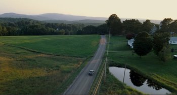 Movie still from “Gone Baby Gone” (2007), directed by Ben Affleck – An aerial view of a car driving down the road; Extreme Wide shot, High angle