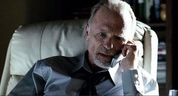 Movie still from “Gone Baby Gone” (2007), directed by Ben Affleck – An older man is talking on a cell phone; Close Up shot, Low angle
