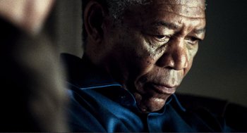 Movie still from “Gone Baby Gone” (2007), directed by Ben Affleck – An older man in a blue shirt is looking down; Close Up shot, Low angle