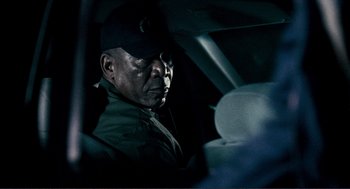 Movie still from “Gone Baby Gone” (2007), directed by Ben Affleck – A man sitting in the driver's seat of a car; Close Up shot, Over the shoulder angle
