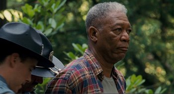 Movie still from “Gone Baby Gone” (2007), directed by Ben Affleck – An older man in a plaid shirt holding a hat in his hand; Close Up shot, Over the shoulder angle