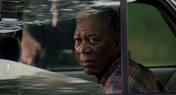 Movie still from “Gone Baby Gone” (2007), directed by Ben Affleck – An older man sitting in a car looking out the window; Close Up shot, Over the shoulder angle