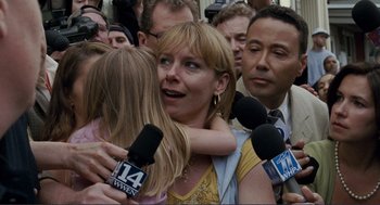 Movie still from “Gone Baby Gone” (2007), directed by Ben Affleck – A group of people with microphones surround a woman; Close Up shot, Over the shoulder angle