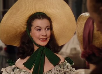 Movie still from “Gone with the Wind” (1939), directed by George Cukor – A woman wearing a green dress and a straw hat; Close Up shot, Over the shoulder angle