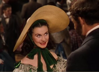 Movie still from “Gone with the Wind” (1939), directed by George Cukor – A woman wearing a hat and a green dress; Close Up shot, Over the shoulder angle
