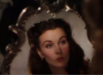Movie still from “Gone with the Wind” (1939), directed by George Cukor – A woman looking into a mirror; Close Up shot, High angle