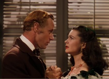 Movie still from “Gone with the Wind” (1939), directed by George Cukor – A man and a woman standing next to each other; Close Up shot, Over the shoulder angle
