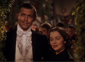 Movie still from “Gone with the Wind” (1939), directed by George Cukor – A man and a woman standing next to each other; Medium shot, Low angle