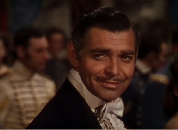 Movie still from “Gone with the Wind” (1939), directed by George Cukor – A man that is wearing a suit and a bow tie; Close Up shot, High angle