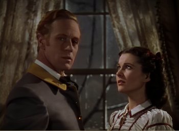 Movie still from “Gone with the Wind” (1939), directed by George Cukor – A man and a woman standing next to each other; Close Up shot, Low angle
