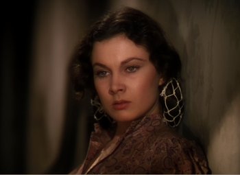 Movie still from “Gone with the Wind” (1939), directed by George Cukor – A beautiful woman with big earrings posing for a picture; Close Up shot, High angle