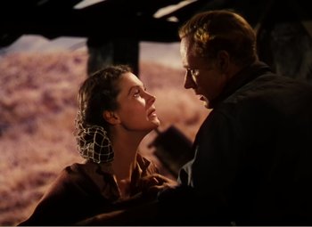 Movie still from “Gone with the Wind” (1939), directed by George Cukor – A man and a woman looking into each others eyes; Medium shot, Low angle