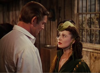 Movie still from “Gone with the Wind” (1939), directed by George Cukor – A man and a woman standing next to each other; Close Up shot, Over the shoulder angle