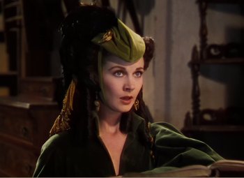 Movie still from “Gone with the Wind” (1939), directed by George Cukor – A woman in a green dress and a green hat; Close Up shot, Over the shoulder angle
