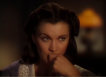 Movie still from “Gone with the Wind” (1939), directed by George Cukor – A person holding their finger to her mouth; Close Up shot, High angle
