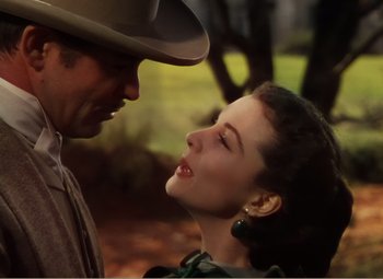 Movie still from “Gone with the Wind” (1939), directed by George Cukor – A man and a woman are looking into each others eyes; Close Up shot, Low angle