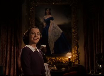 Movie still from “Gone with the Wind” (1939), directed by George Cukor – A woman standing in front of a painting of a woman; Medium shot, Low angle