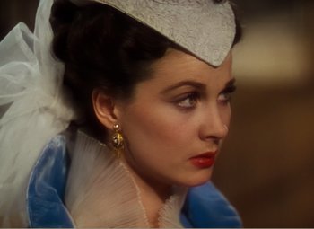 Movie still from “Gone with the Wind” (1939), directed by George Cukor – A person wearing a dress and a hat; Close Up shot, Over the shoulder angle