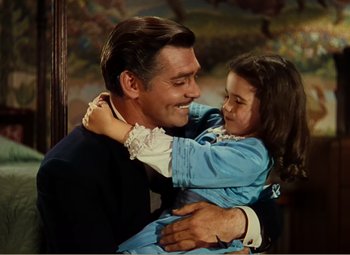 Movie still from “Gone with the Wind” (1939), directed by George Cukor – A man and a little girl are hugging each other; Medium shot, High angle