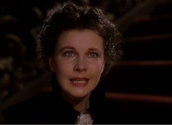 Movie still from “Gone with the Wind” (1939), directed by George Cukor – A person wearing a suit and tie; Close Up shot, High angle