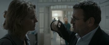 Movie still from “Graduation” (2016), directed by Cristian Mungiu – A man and a woman in a room; Medium shot, Over the shoulder angle